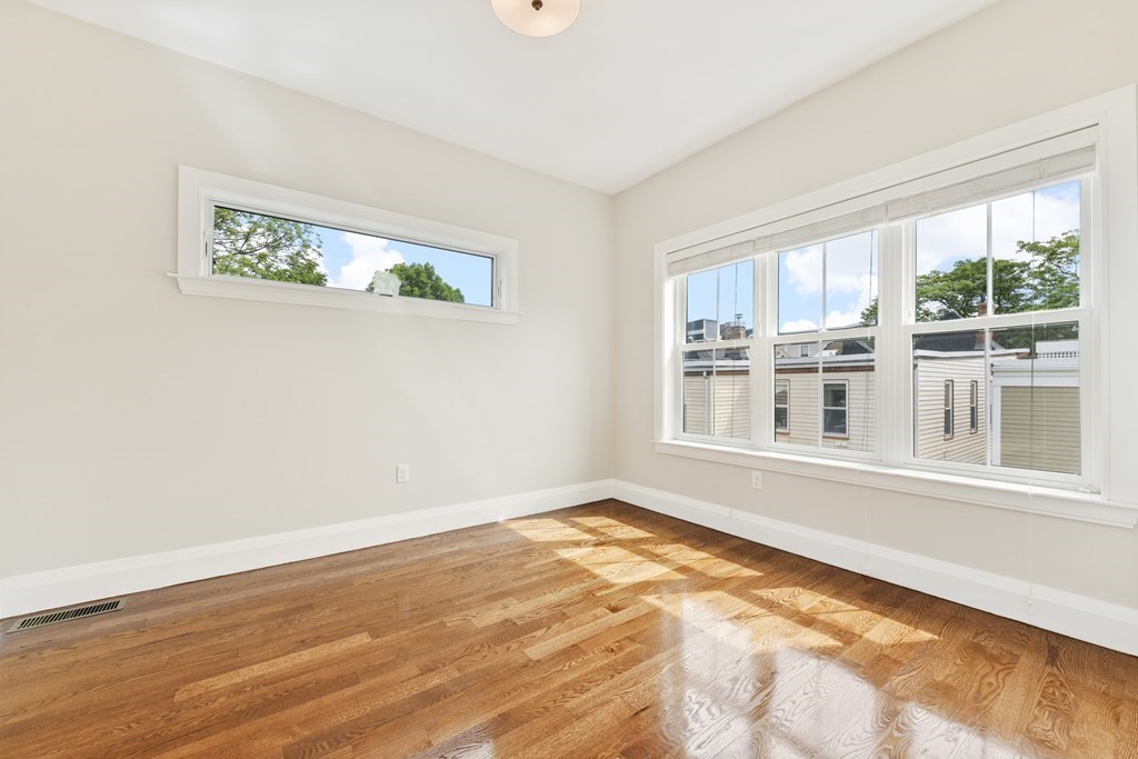 1514 R Columbia Road, Unit 2 Boston, MA 02127 - Photo 10 of 28 a view of an empty room with wooden floor and a window