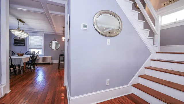 a view of entryway with dining room and wooden floor