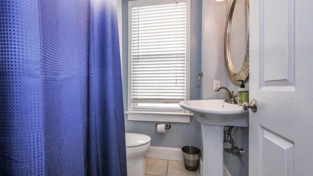 a bathroom with a sink a toilet and a mirror