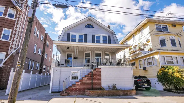 a front view of a residential apartment building with a yard