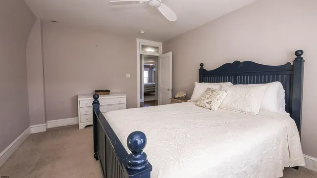 a bedroom with a bed and a large mirror