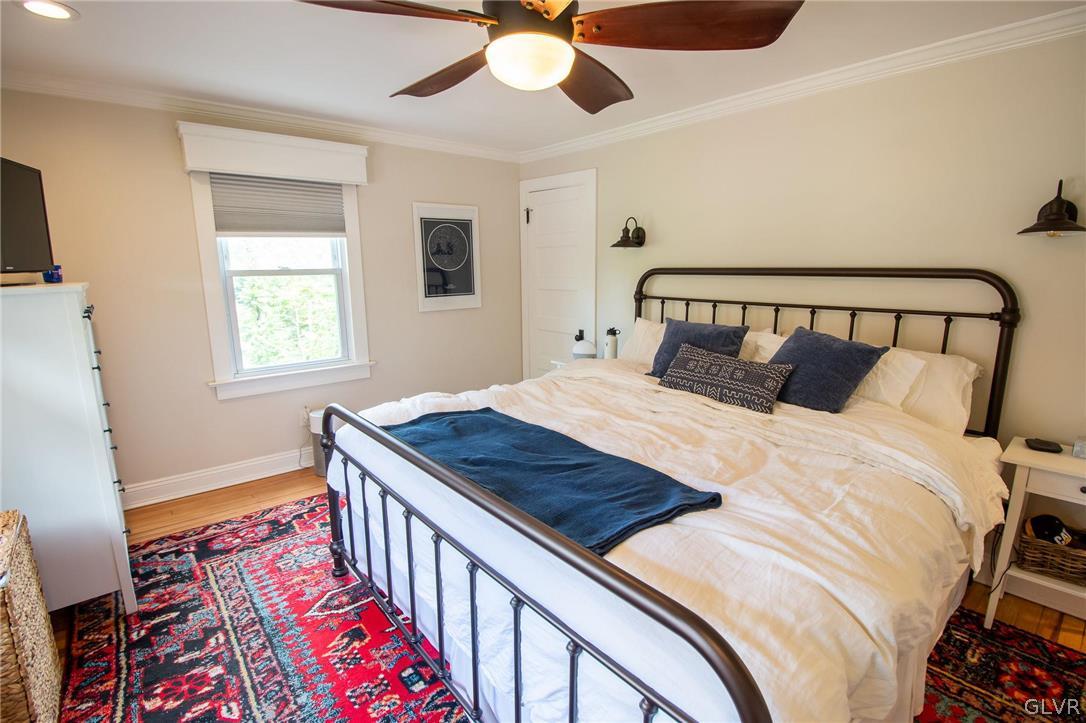 817 Easton Road Riegelsville, PA 18077 - Photo 30 of 43 a bedroom with a bed and a chandelier