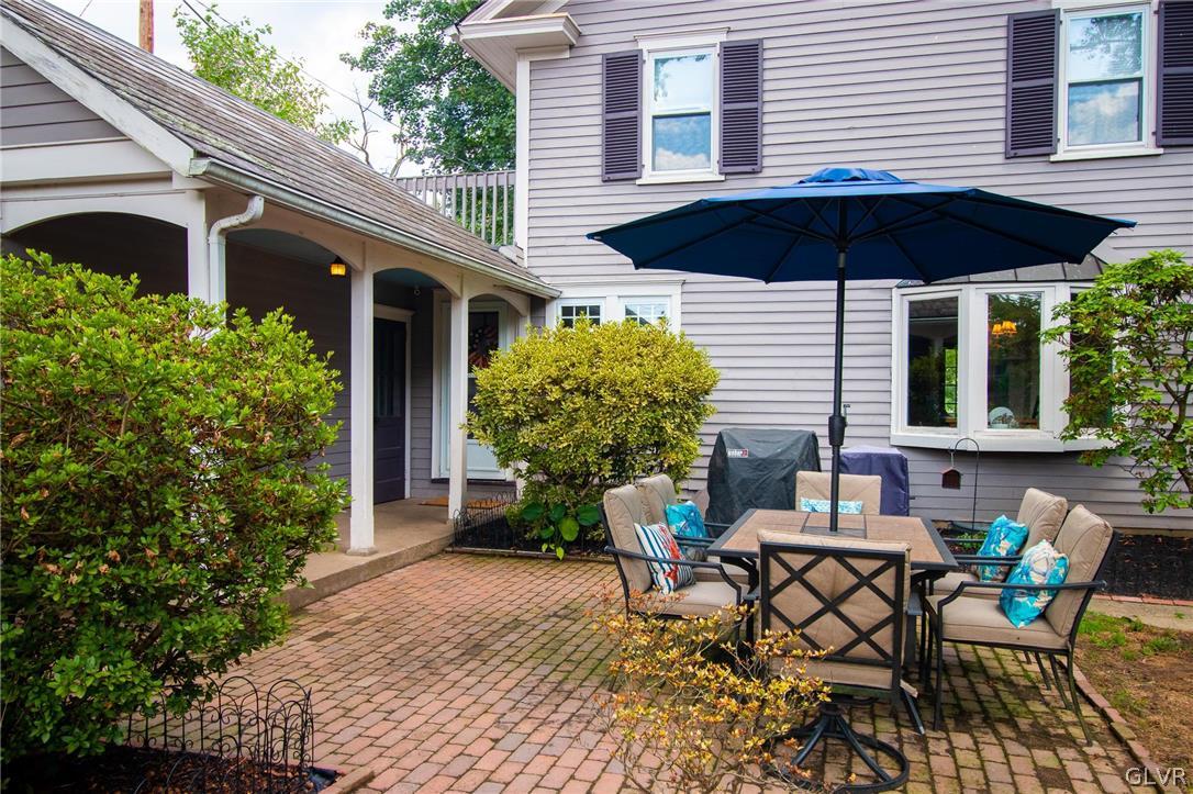 817 Easton Road Riegelsville, PA 18077 - Photo 3 of 43 a backyard of a house with table and chairs with an umbrella