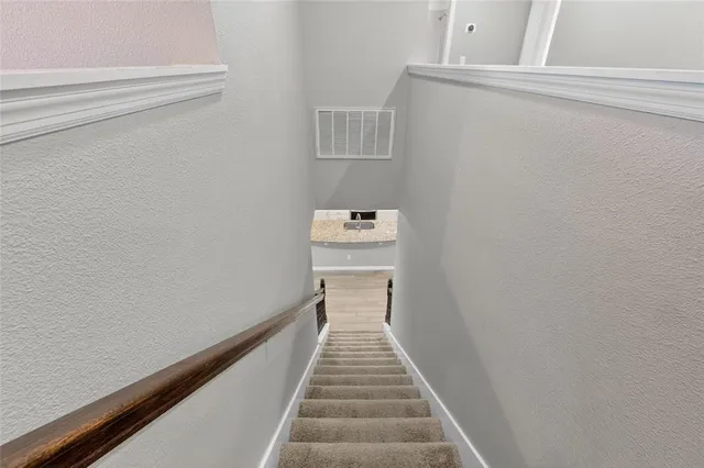 a view of a hallway with stairs
