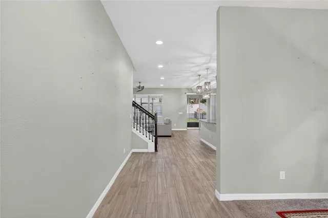 a view of a hallway with wooden floor