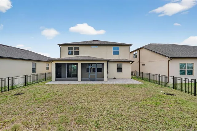 a view of a house with a yard and sitting area