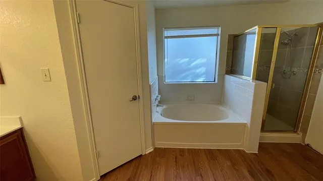 a bathroom with a bathtub and a shower