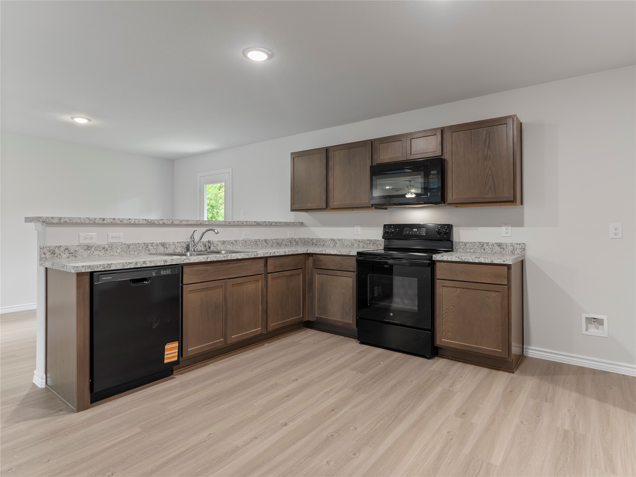 306 North Orange Street Sweeny, TX 77480 - Photo 9 of 30 Stylish kitchen featuring sleek black appliances.