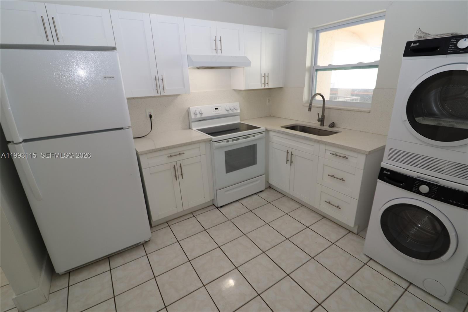 a kitchen with a washer and dryer