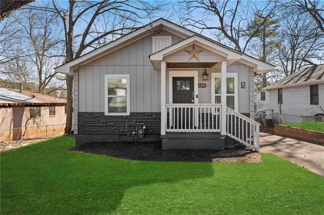 a view of a house with a yard and deck