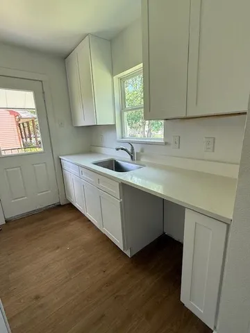 a kitchen with a sink and cabinets