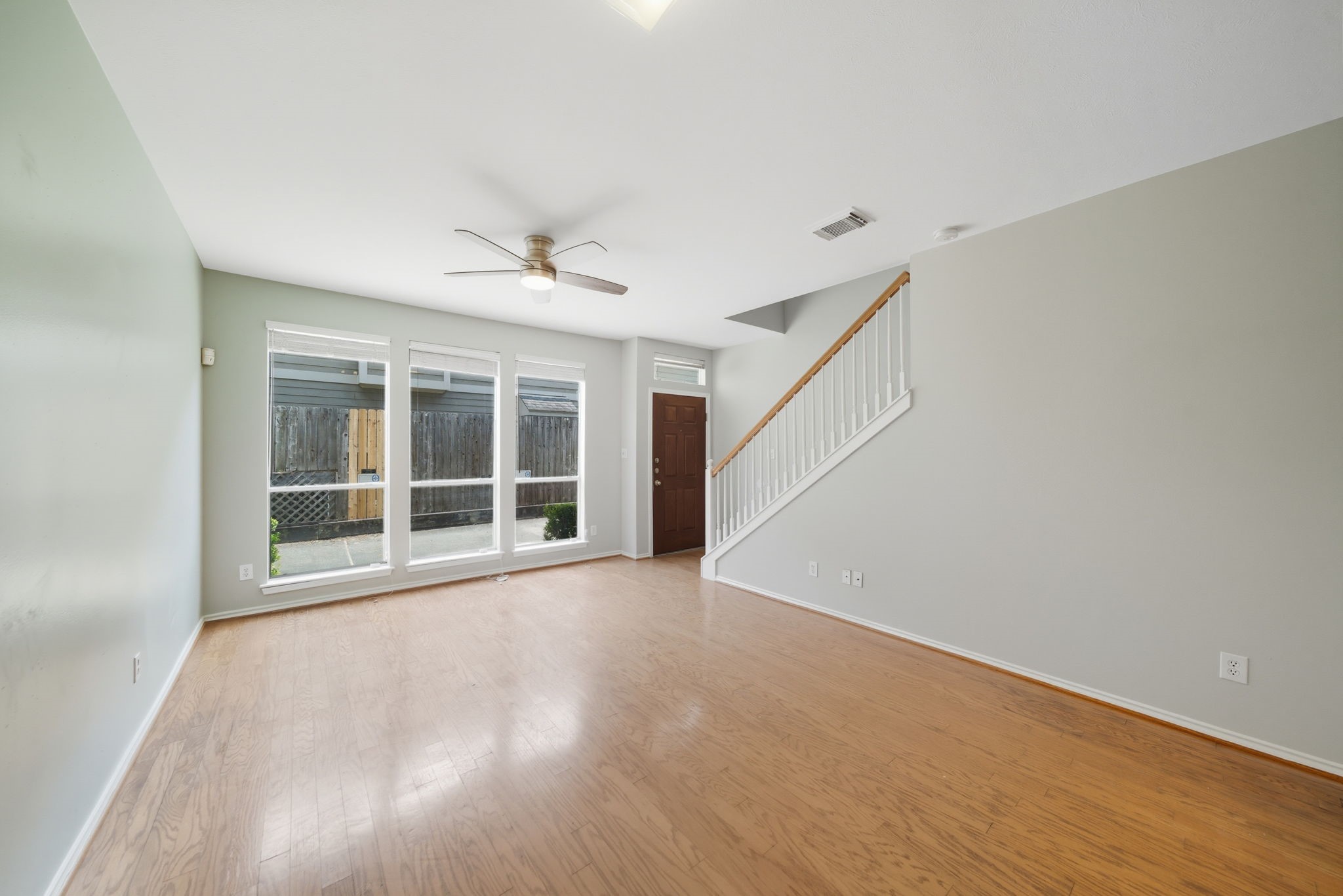 1507 Sutton Street Houston, TX 77006 - Photo 2 of 22 a view of an empty room with a window and wooden floor