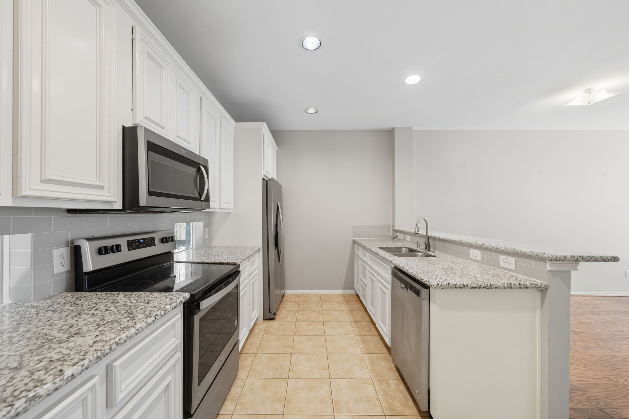 1507 Sutton Street Houston, TX 77006 - Photo 6 of 22 a kitchen with stainless steel appliances granite countertop a sink stove and refrigerator
