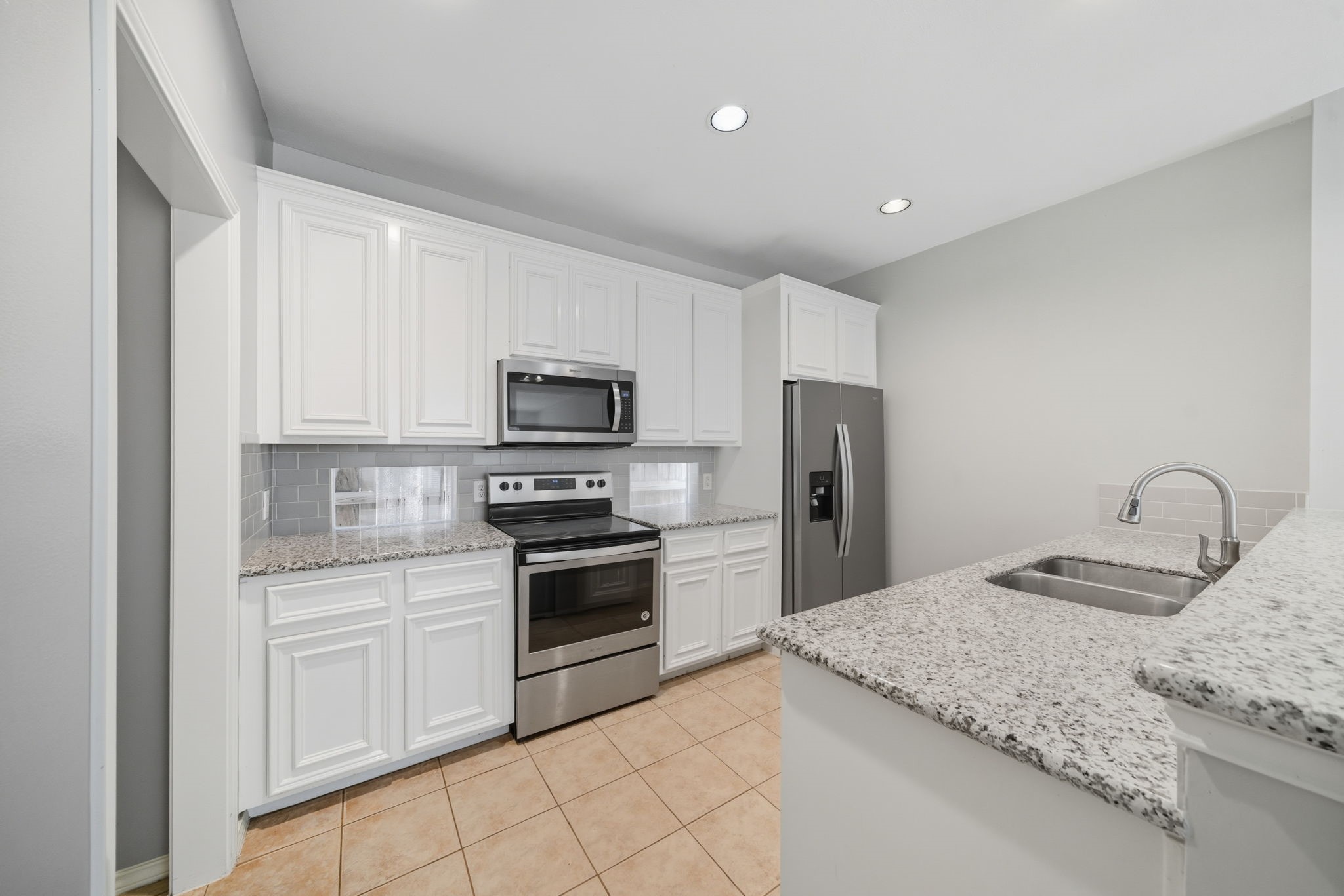 1507 Sutton Street Houston, TX 77006 - Photo 7 of 22 a kitchen with granite countertop a stove sink and refrigerator