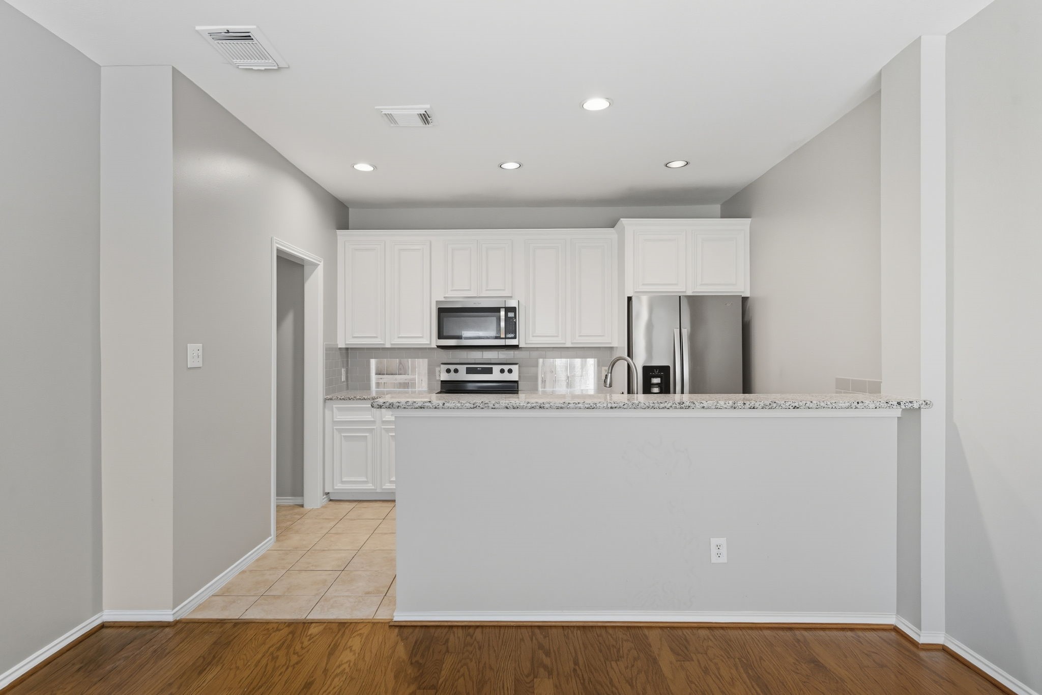 1507 Sutton Street Houston, TX 77006 - Photo 8 of 22 a kitchen with stainless steel appliances a refrigerator and a stove top oven