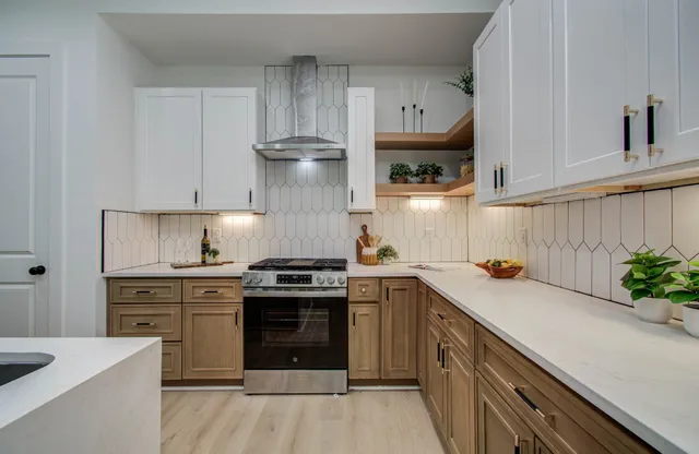a kitchen with stainless steel appliances a stove a sink and a refrigerator