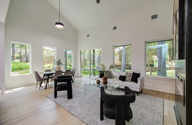 a living room with furniture and large windows
