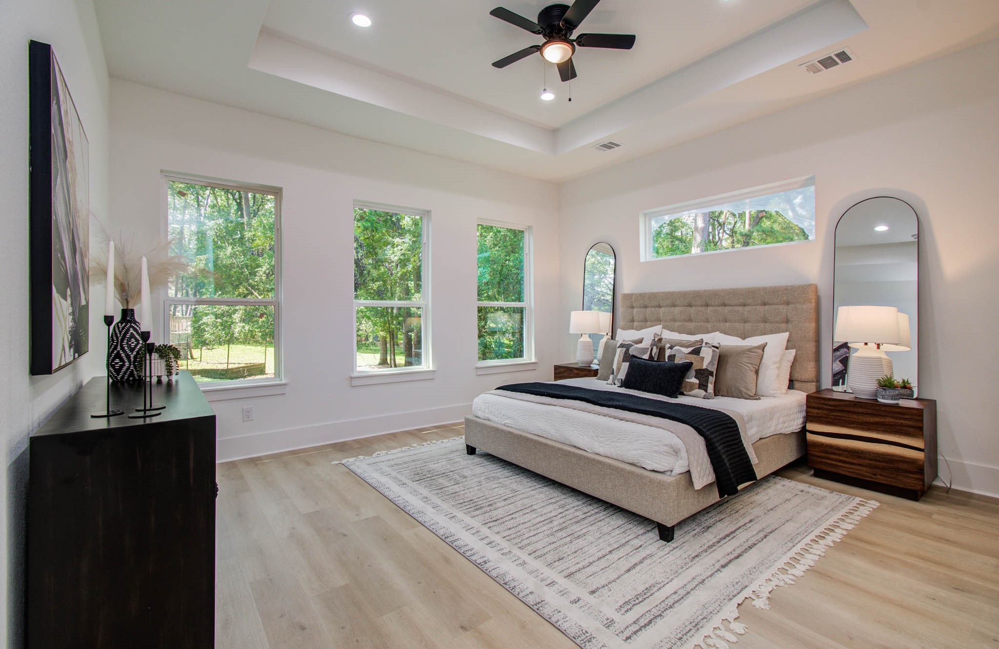 1802 Rollingwood Drive Huntsville, TX 77340 - Photo 15 of 38 a bedroom with a bed and a chandelier