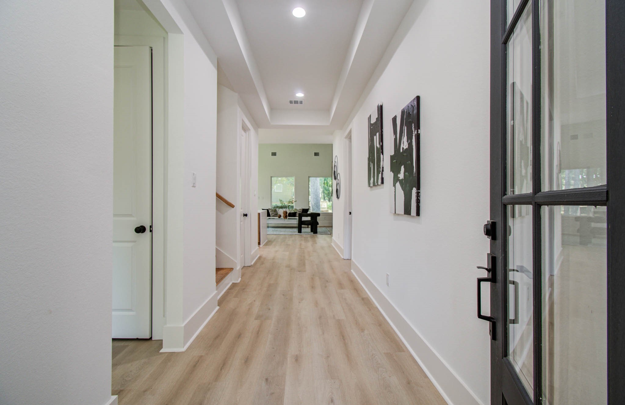 1802 Rollingwood Drive Huntsville, TX 77340 - Photo 2 of 38 a view of a hallway with wooden floor and staircase