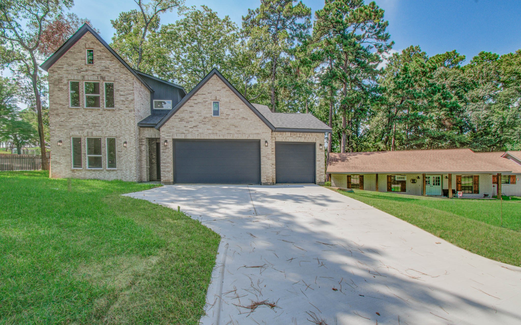 1802 Rollingwood Drive Huntsville, TX 77340 - Photo 30 of 38 a front view of a house with a yard and garage