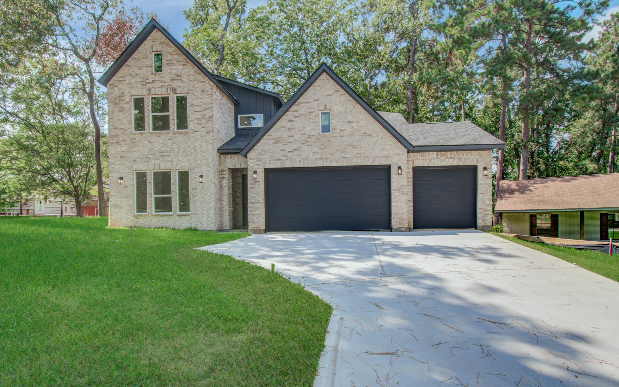 1802 Rollingwood Drive Huntsville, TX 77340 - Photo 34 of 38 a front view of a house with a yard and garage