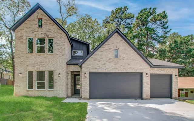 a view of a house with a yard and flower plants