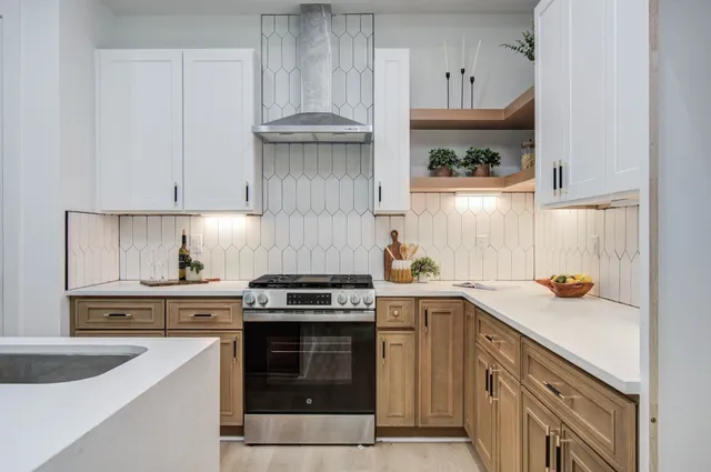 a kitchen with a sink a stove and cabinets