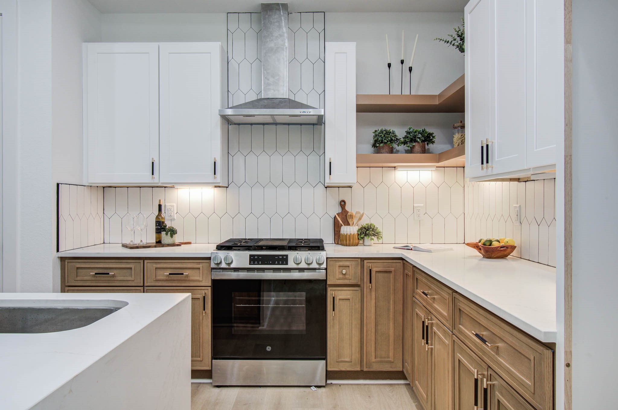 1802 Rollingwood Drive Huntsville, TX 77340 - Photo 9 of 38 a kitchen with a sink a stove and cabinets