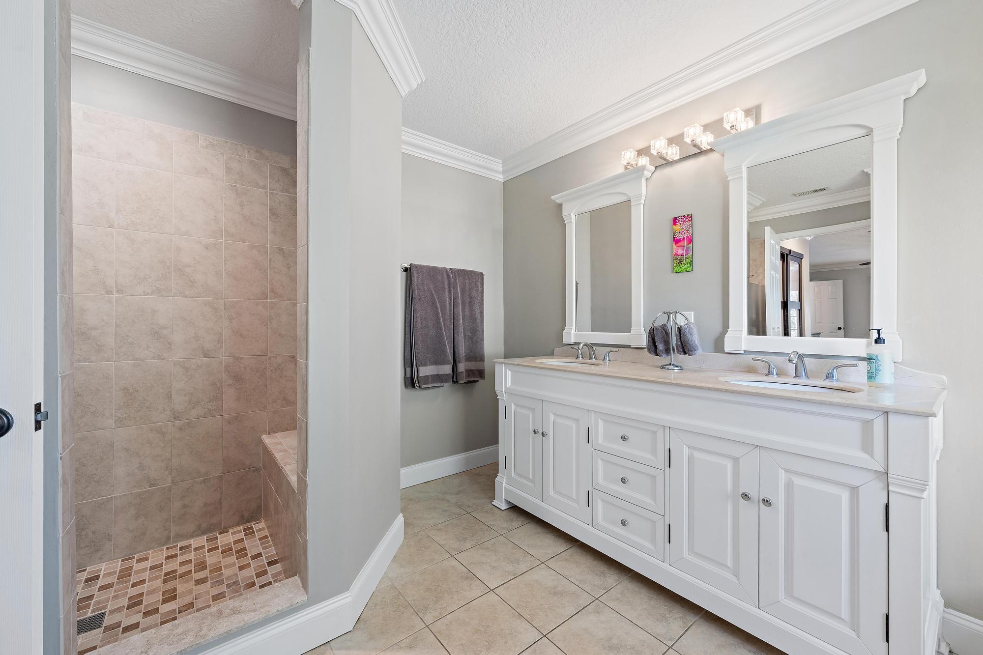 12177 86th Road North West Palm Beach, FL 33412 - Photo 17 of 40 a bathroom with a granite countertop sink and a mirror