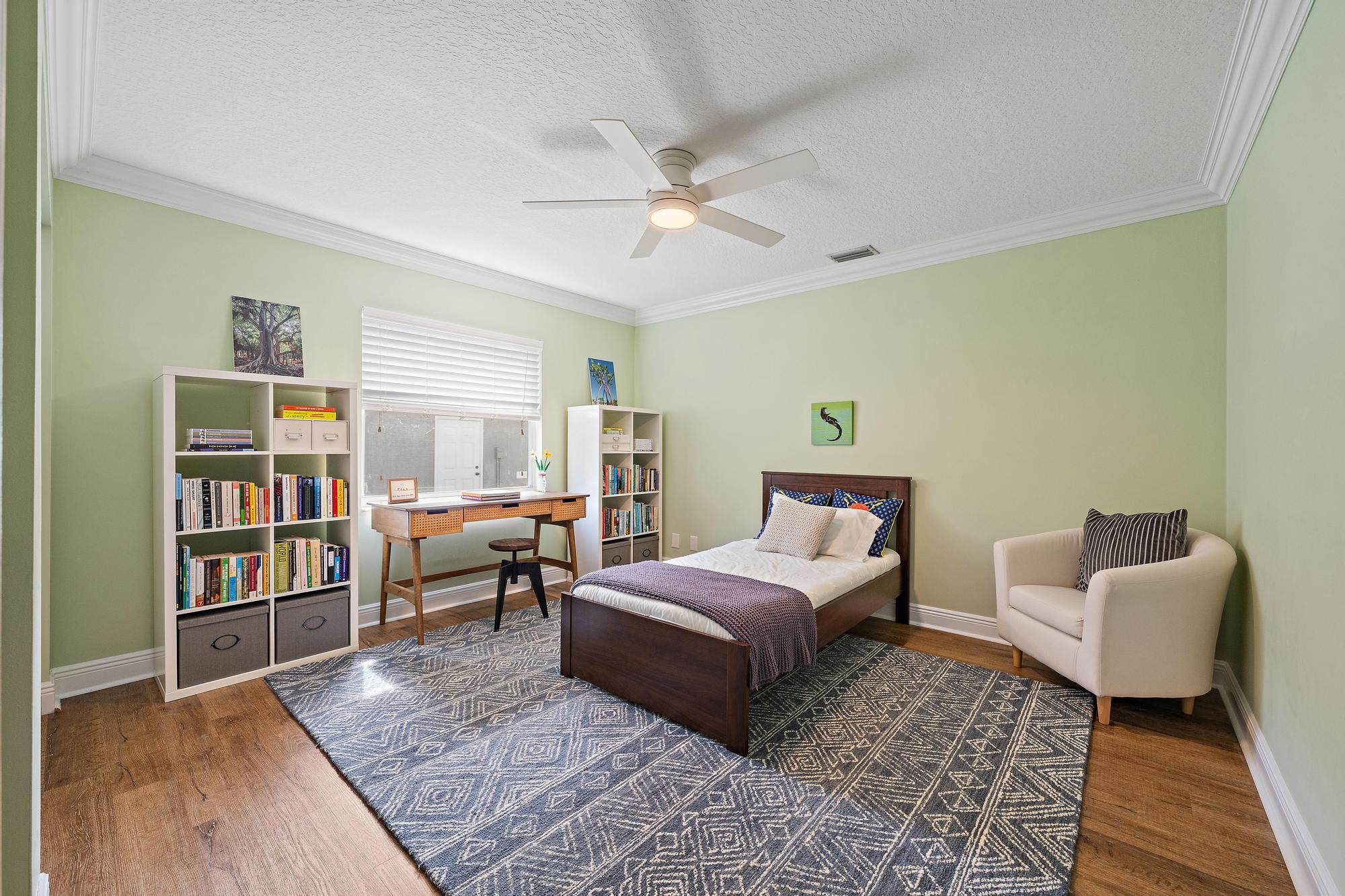 12177 86th Road North West Palm Beach, FL 33412 - Photo 20 of 40 a spacious bedroom with a bed and a book shelf