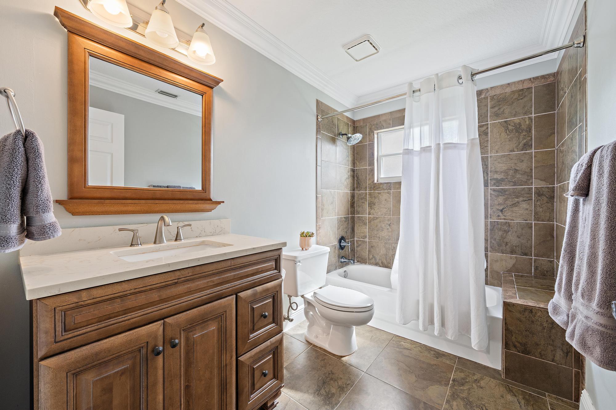 12177 86th Road North West Palm Beach, FL 33412 - Photo 21 of 40 a bathroom with a sink a toilet a mirror and shower