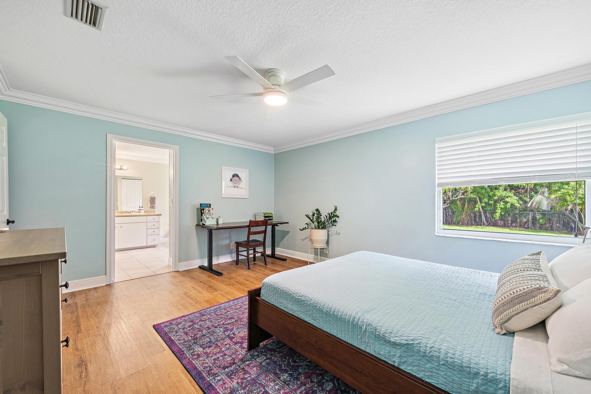 12177 86th Road North West Palm Beach, FL 33412 - Photo 23 of 40 a bedroom with a bed and wooden floor