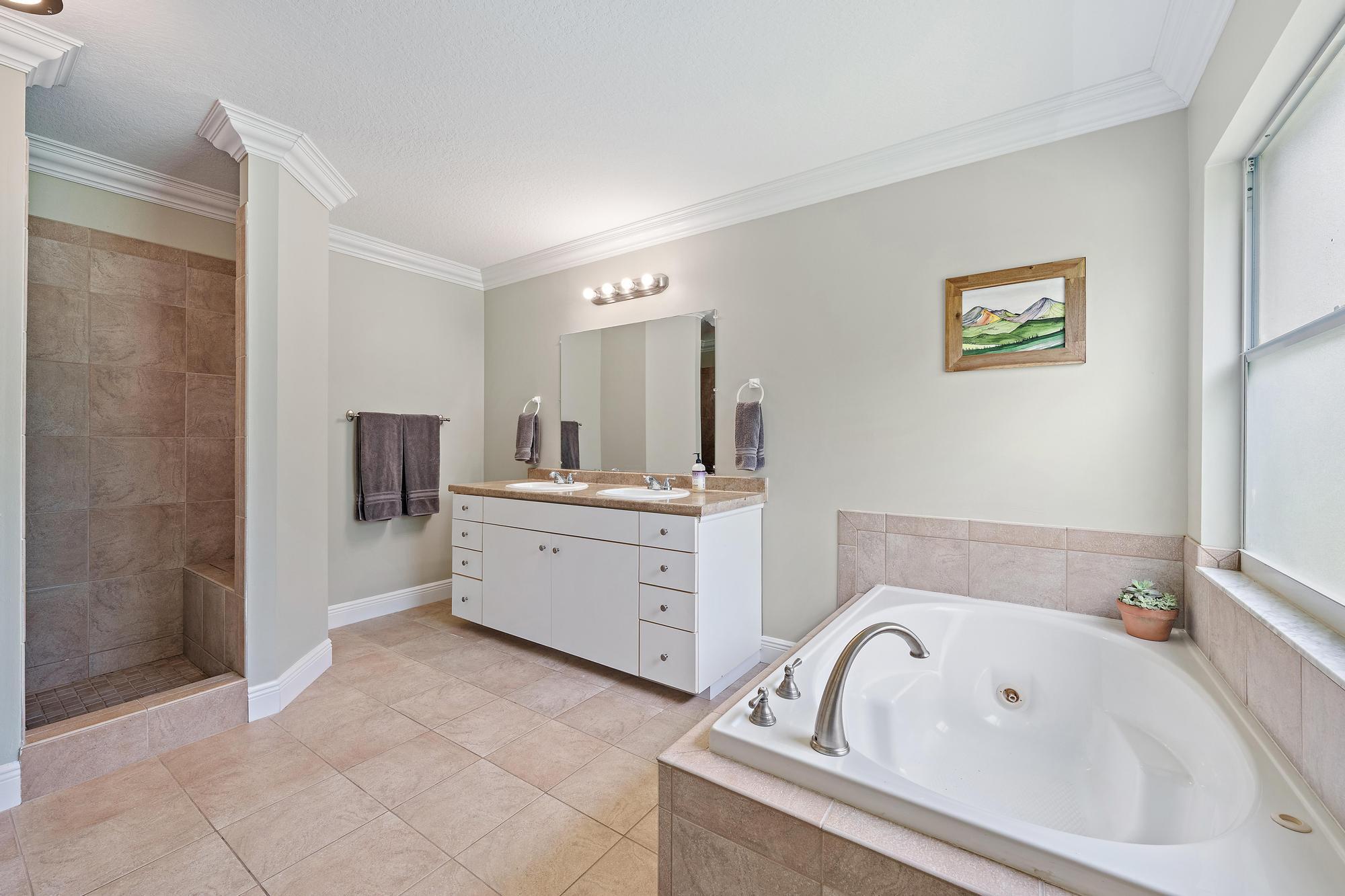 12177 86th Road North West Palm Beach, FL 33412 - Photo 24 of 40 a bathroom with a bathtub sink and mirror
