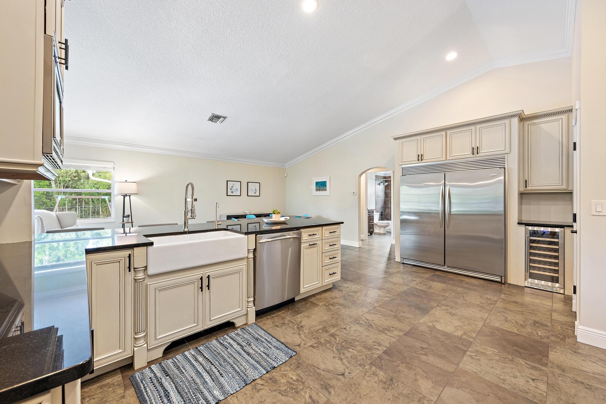 12177 86th Road North West Palm Beach, FL 33412 - Photo 27 of 40 a kitchen with counter top space cabinets and stainless steel appliances