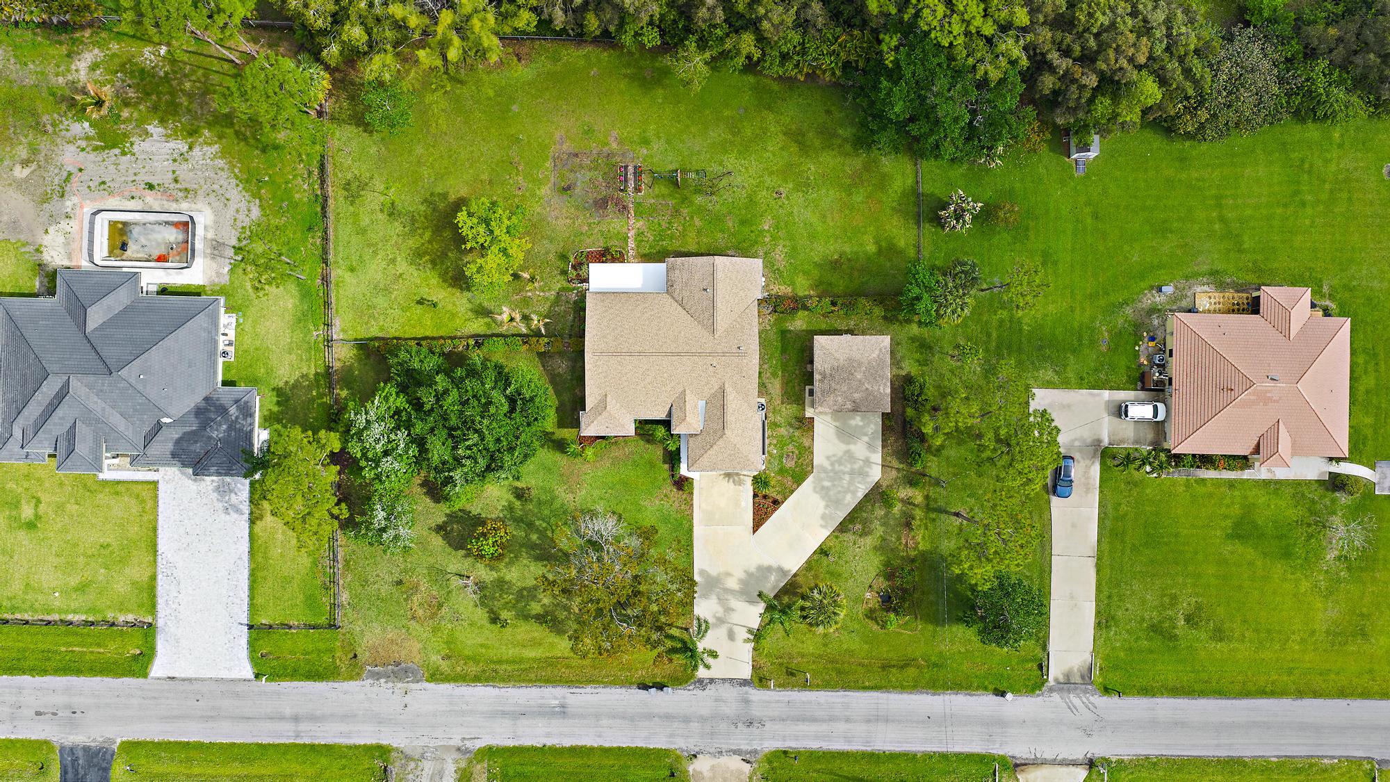 12177 86th Road North West Palm Beach, FL 33412 - Photo 33 of 40 an aerial view of a house with a yard