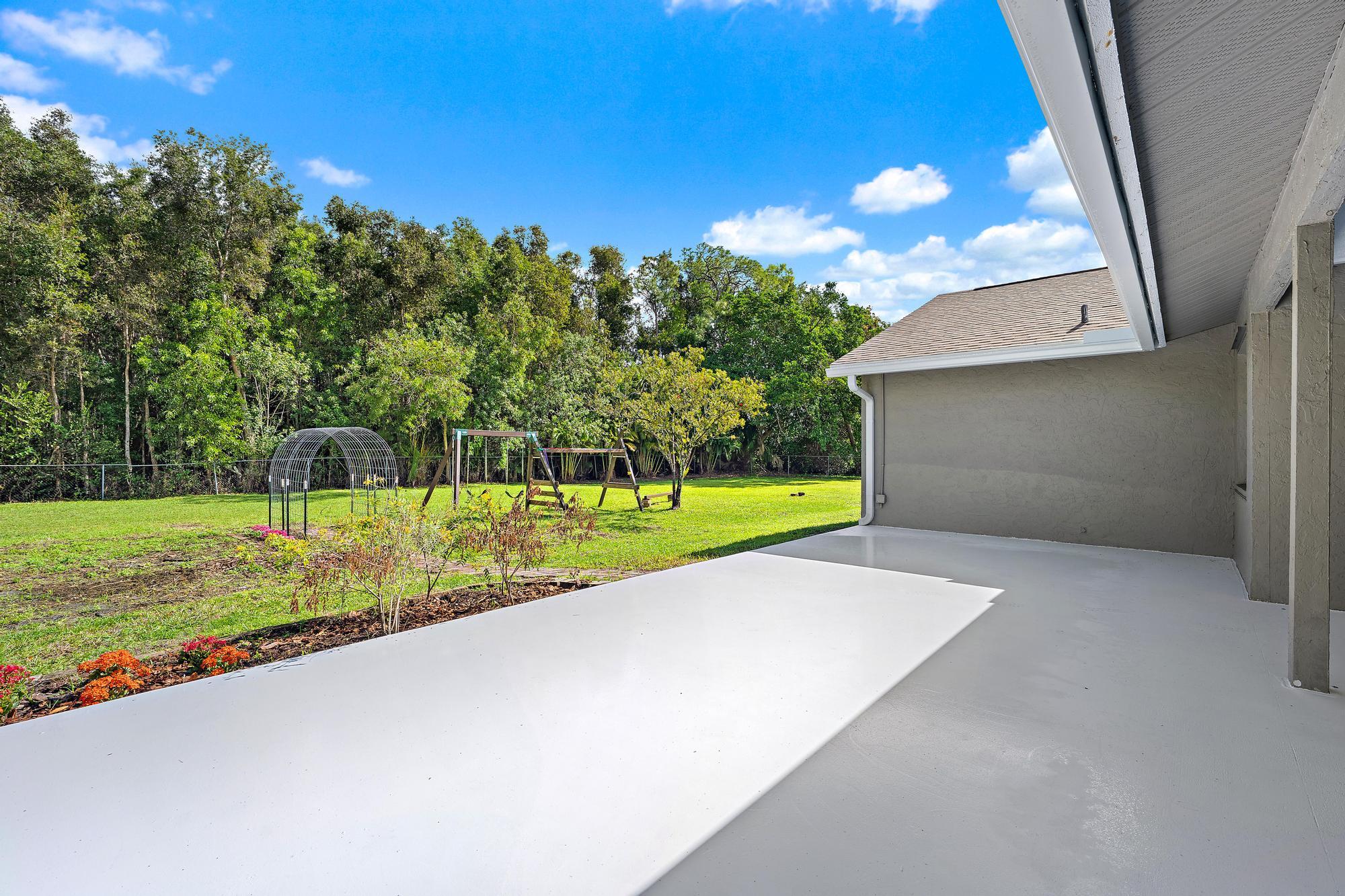12177 86th Road North West Palm Beach, FL 33412 - Photo 6 of 40 a view of a house with a yard