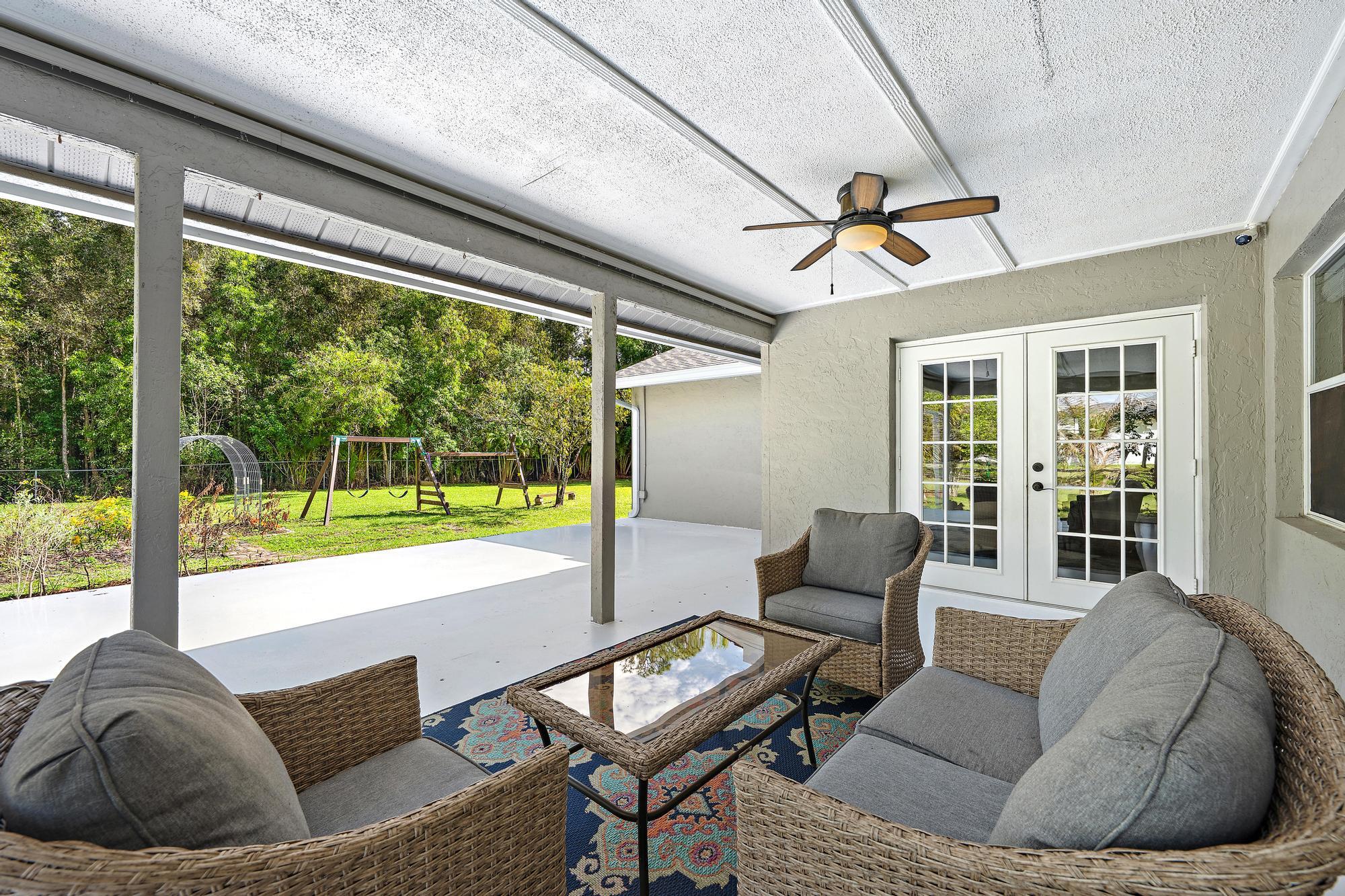 12177 86th Road North West Palm Beach, FL 33412 - Photo 7 of 40 a living room with furniture and a floor to ceiling window