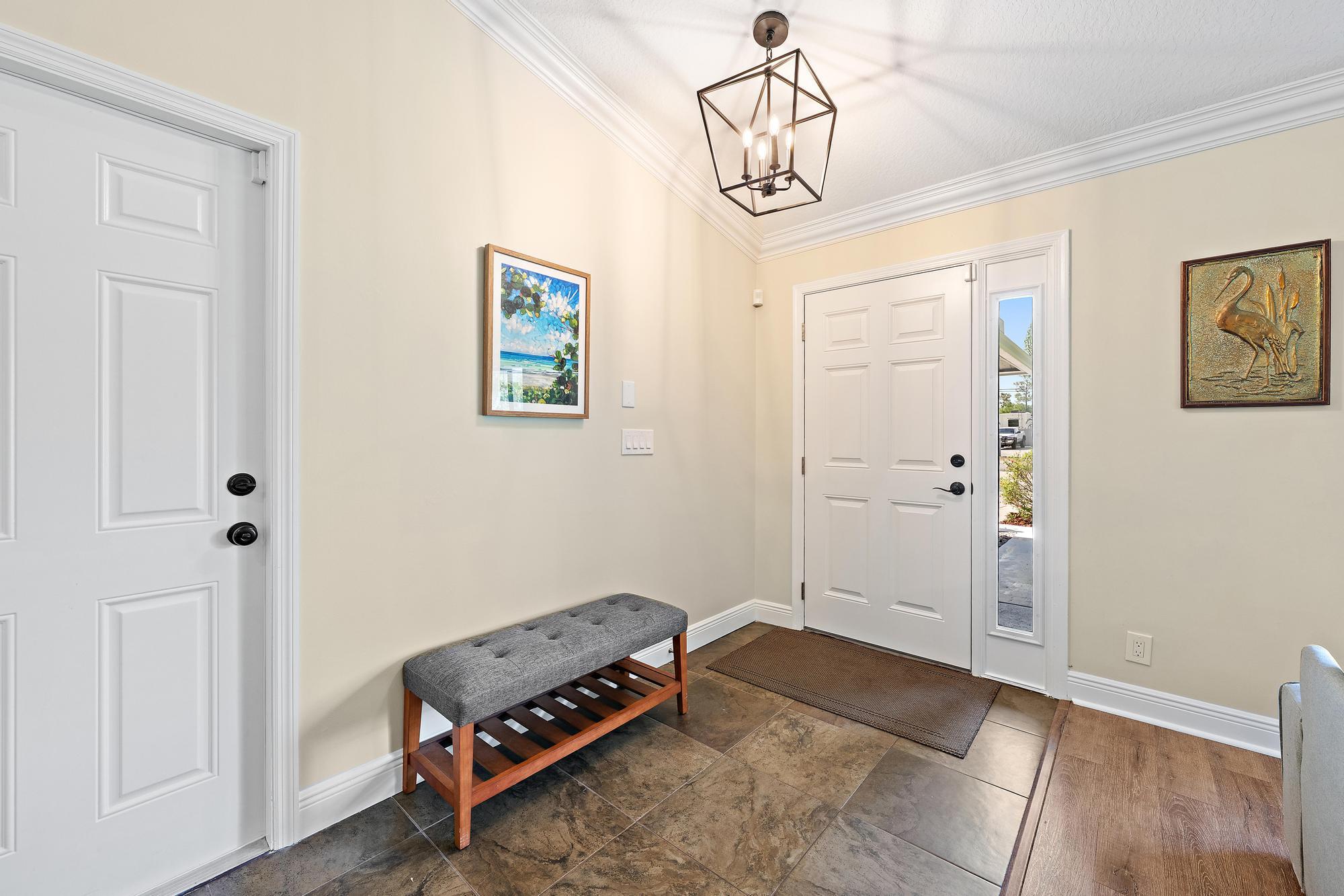 12177 86th Road North West Palm Beach, FL 33412 - Photo 9 of 40 a living room with a dining table and a wooden floor