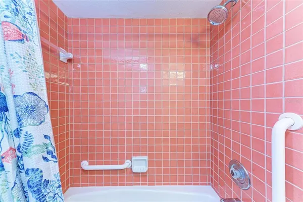 a bathroom with a bathtub and shower