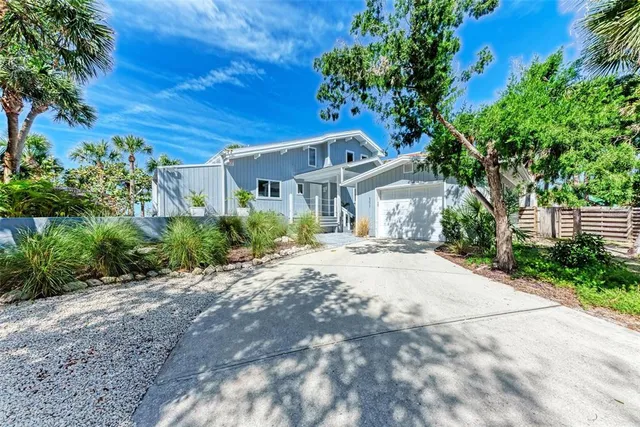 a bedroom with furniture and a large window