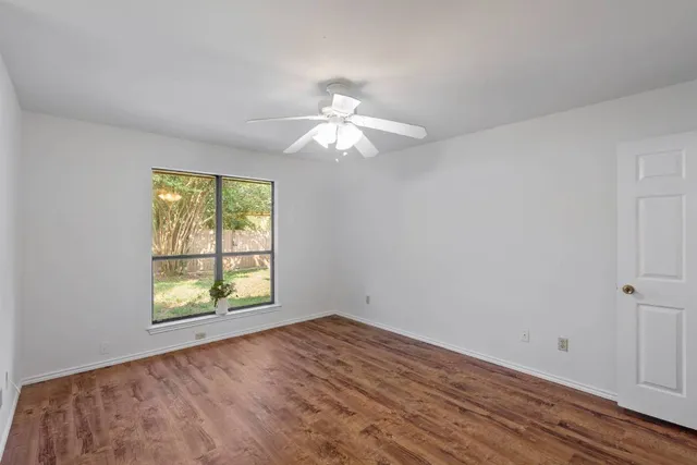 a bathroom with a toilet and a shower curtain