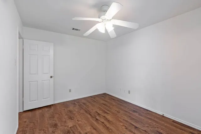 a kitchen with stainless steel appliances a sink a stove a refrigerator cabinets and a dining table