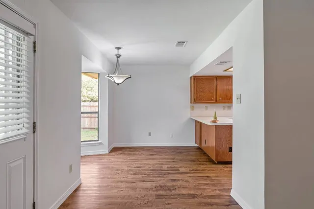a view of room with wooden floor