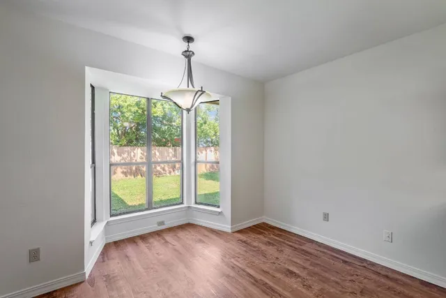 a kitchen with stainless steel appliances granite countertop wooden cabinets a stove top oven a sink and dishwasher