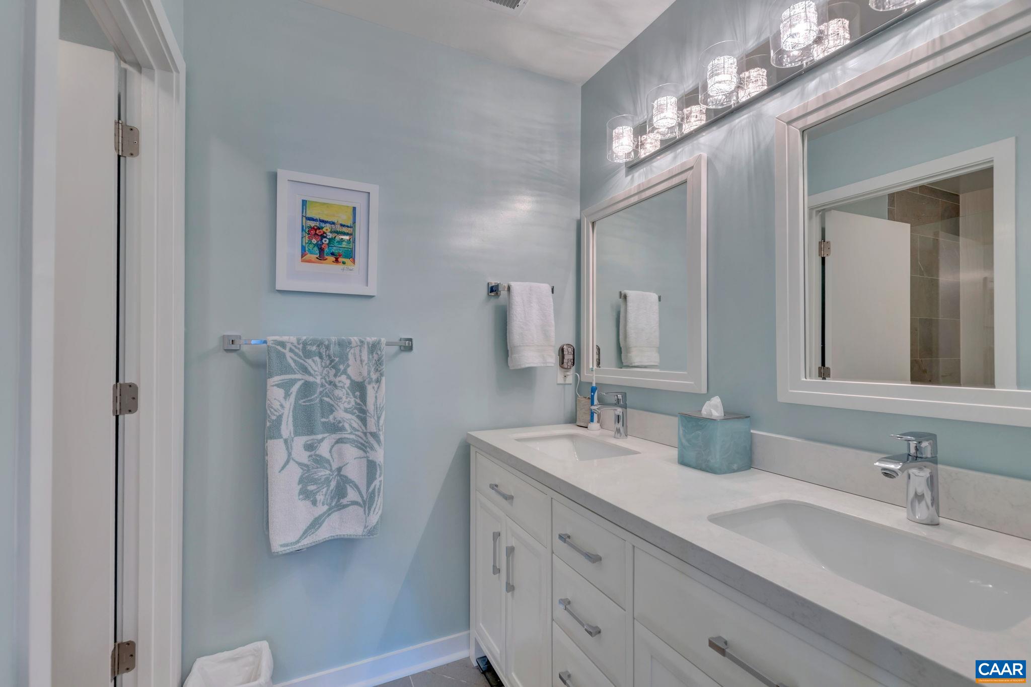17 Bonita Road Palmyra, VA 22963 - Photo 33 of 74 a bathroom with double vanity sinks a vanity and a mirror