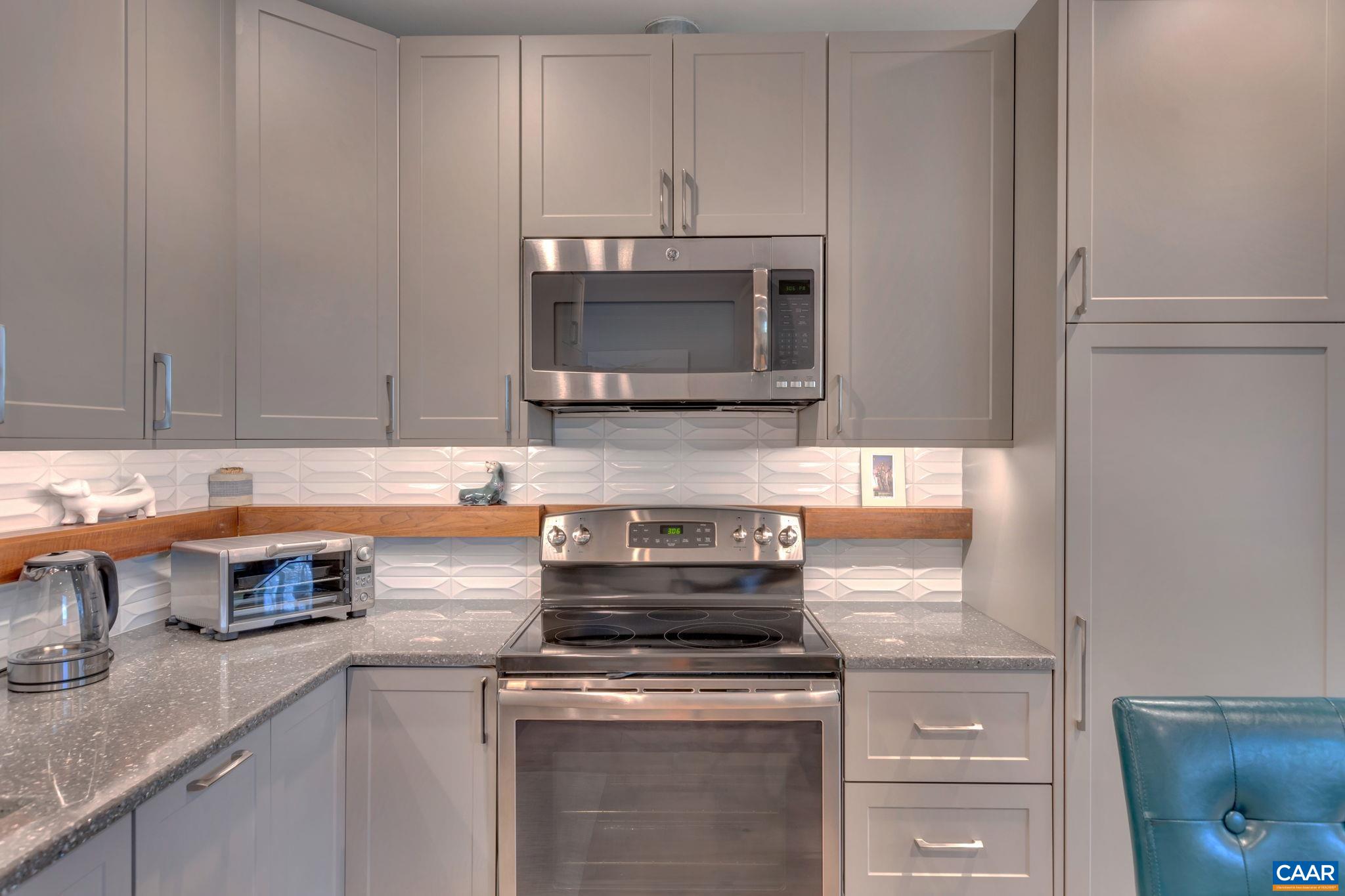 17 Bonita Road Palmyra, VA 22963 - Photo 50 of 74 a kitchen with stainless steel appliances granite countertop a sink stove and microwave