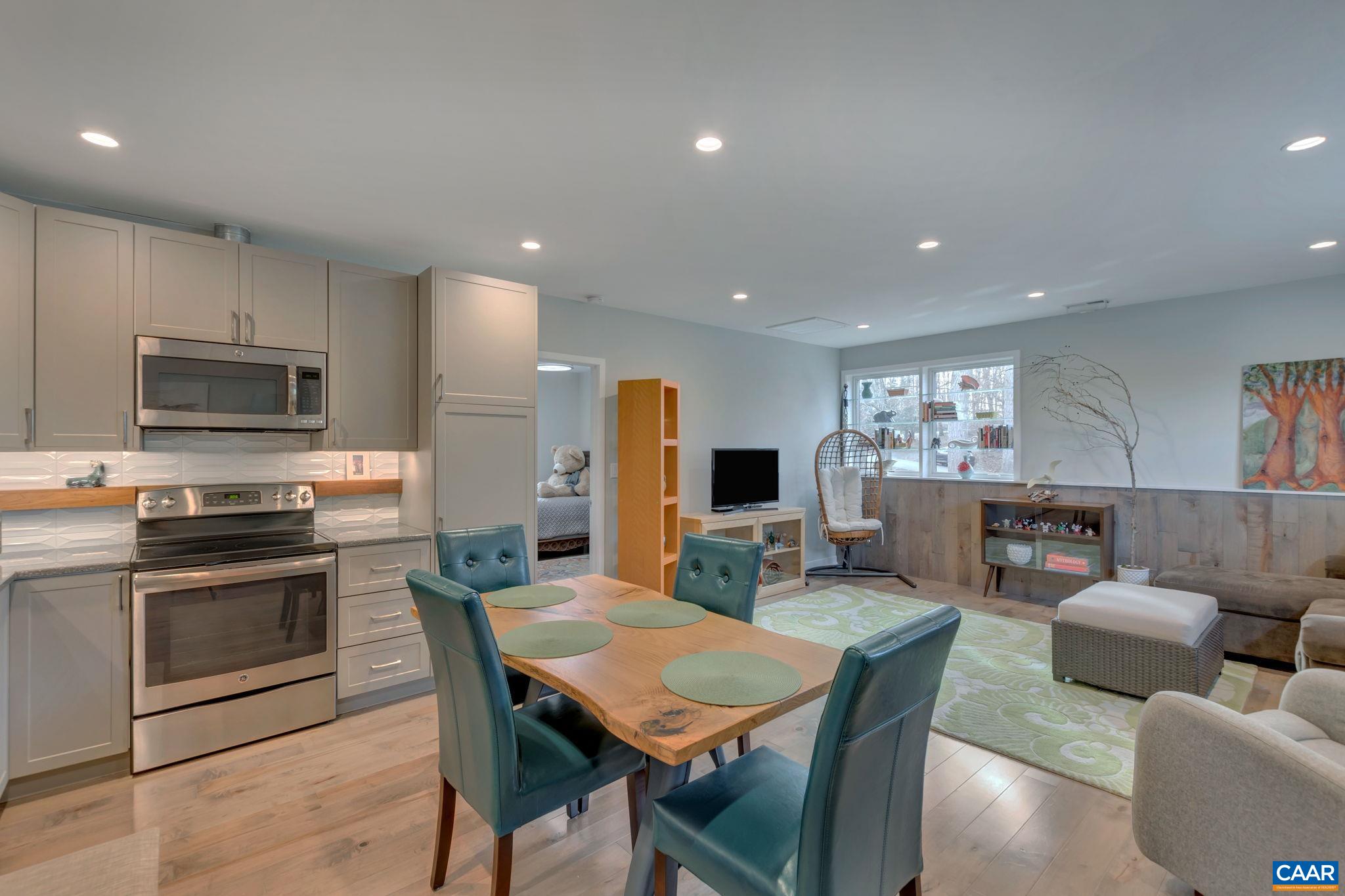 17 Bonita Road Palmyra, VA 22963 - Photo 51 of 74 a kitchen with stainless steel appliances granite countertop a stove a sink a microwave a dining table and chairs