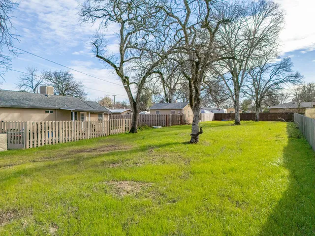 a view of a swimming pool with a yard