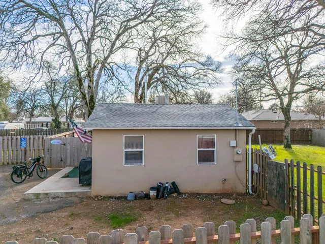 a backyard of a house with table and chairs