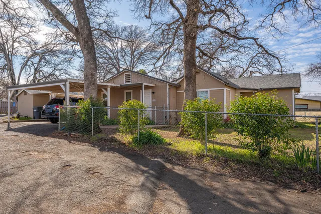 a front view of a house with a garden and plants